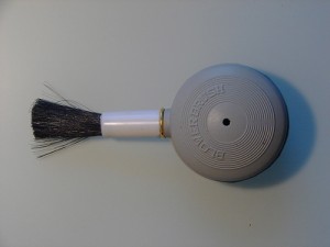 Anti-static brush for camera lenses